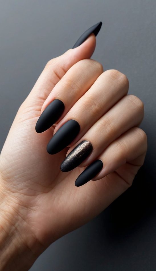 A close-up of dark, elegant nails against a matte onyx backdrop