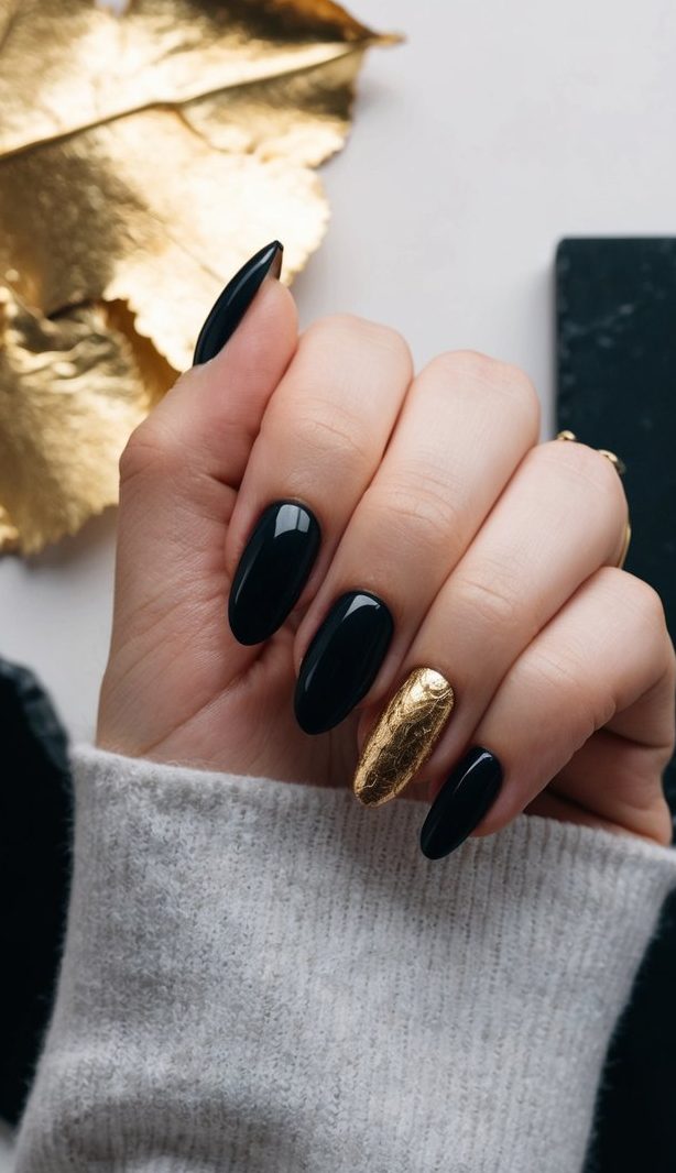 Deep, mysterious nails against a backdrop of gold leaf and onyx, evoking a moody and elegant atmosphere