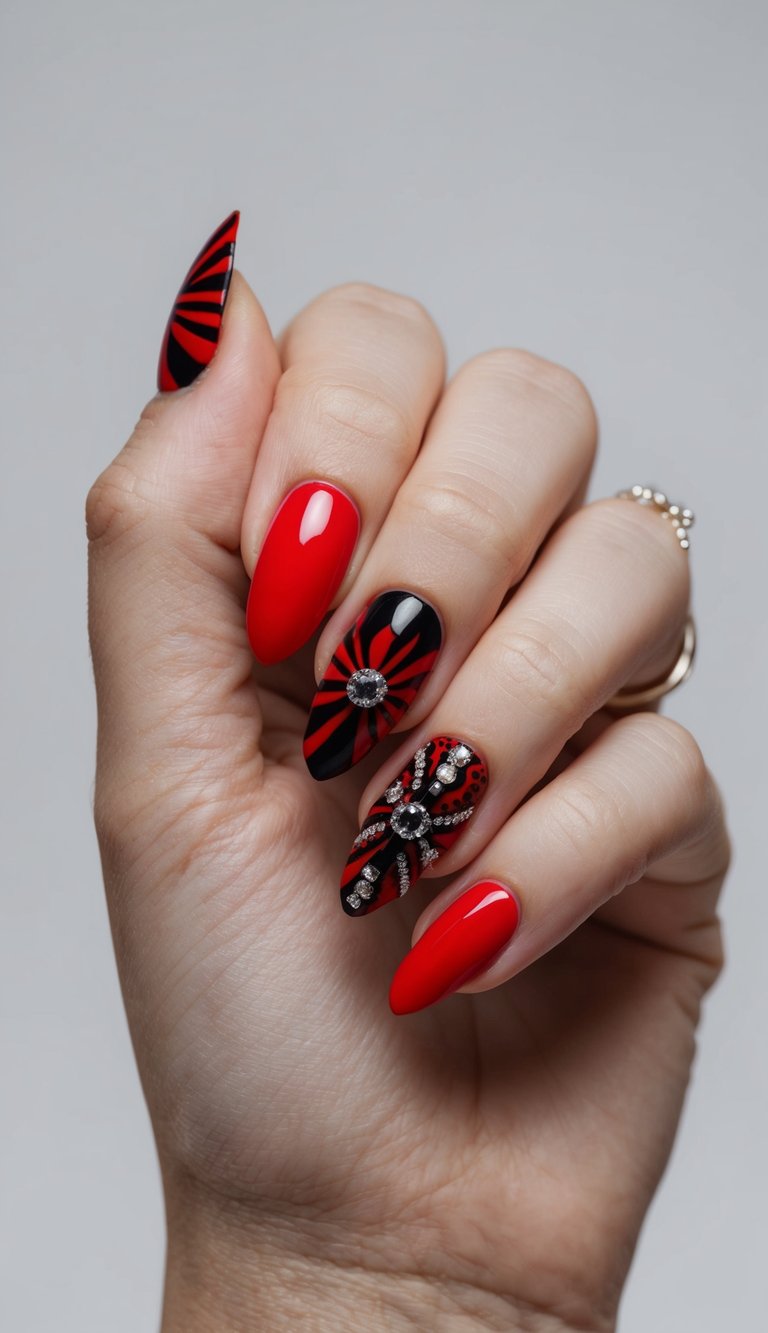 Manicured hand angled upward displaying red and black wedding nails with bright red shine, black striped detailing, and raised crystal embellishments centered on accent nails.
