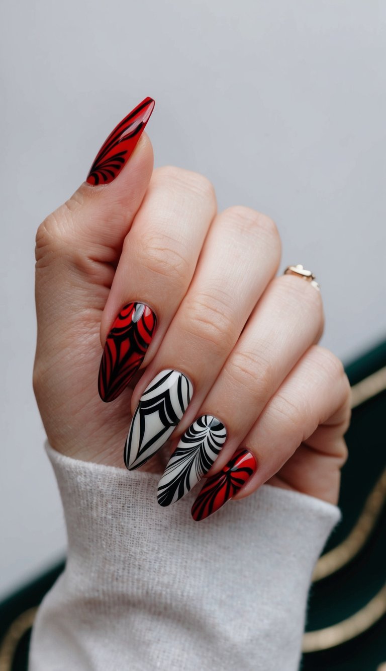 Hand posed against a light backdrop featuring red and black wedding nails with vivid red polish, sweeping black spiral artwork, and a creamy white accent nail etched in bold curved striping.