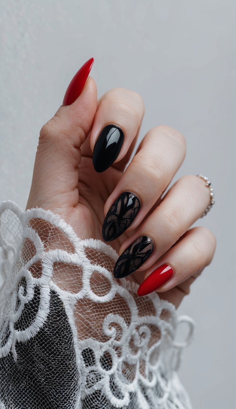Manicured hand showcasing red and black wedding nails, including glossy red tips, smooth black nails, and two intricate lace-patterned black accents beside a bridal-style lace sleeve.
