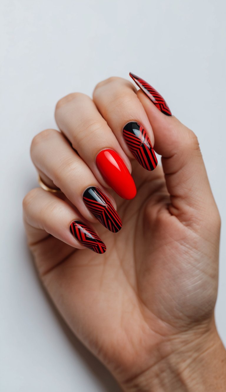 Manicured hand with almond-shaped red and black wedding nails, showing glossy black polish decorated with thin red geometric lines and one solid red feature nail.
