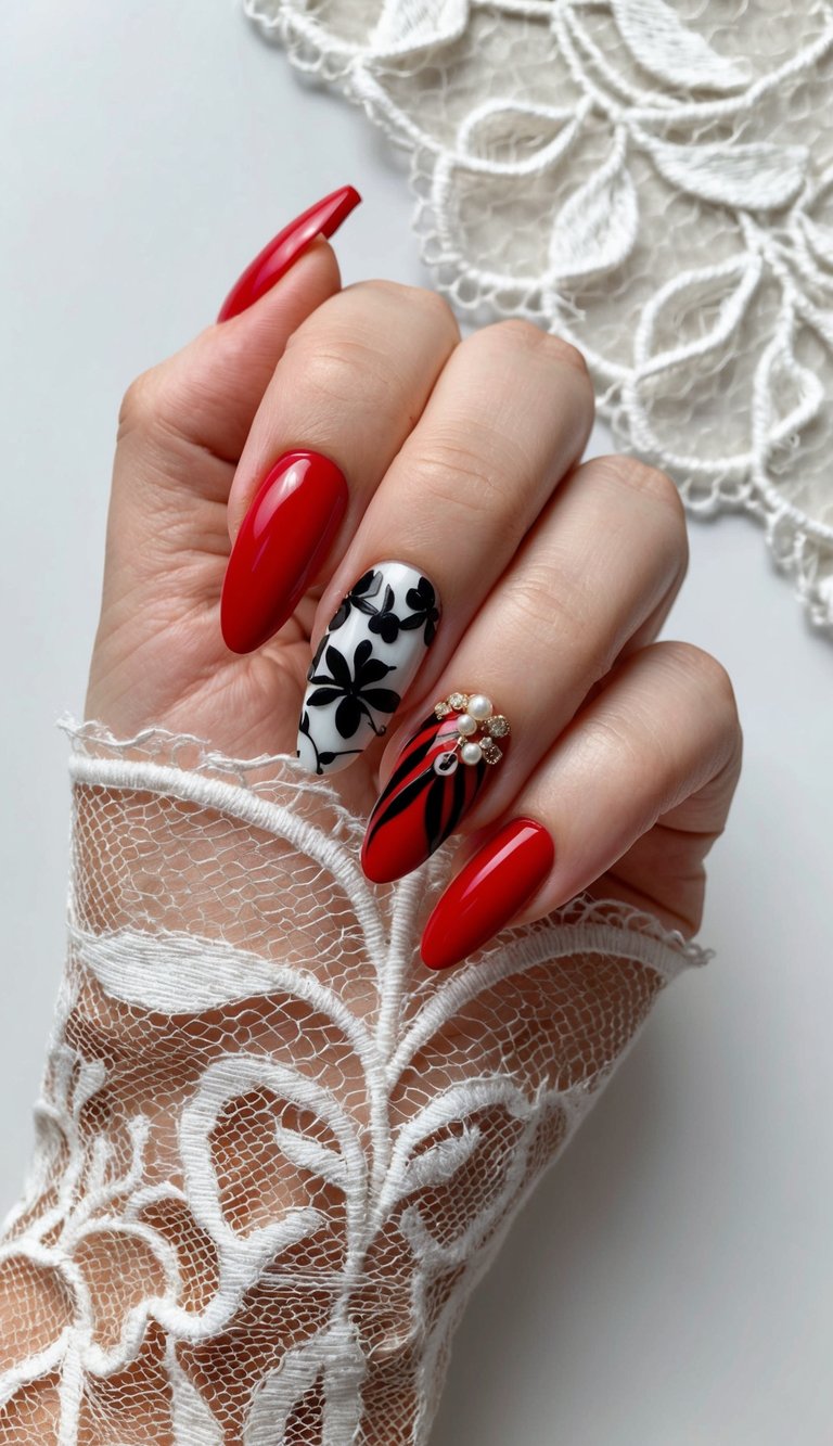 Elegant bridal hand pose displaying red and black wedding nails, highlighting bright red almond nails, black floral artwork on a white base, and a textured pearl and stripe accent nail.